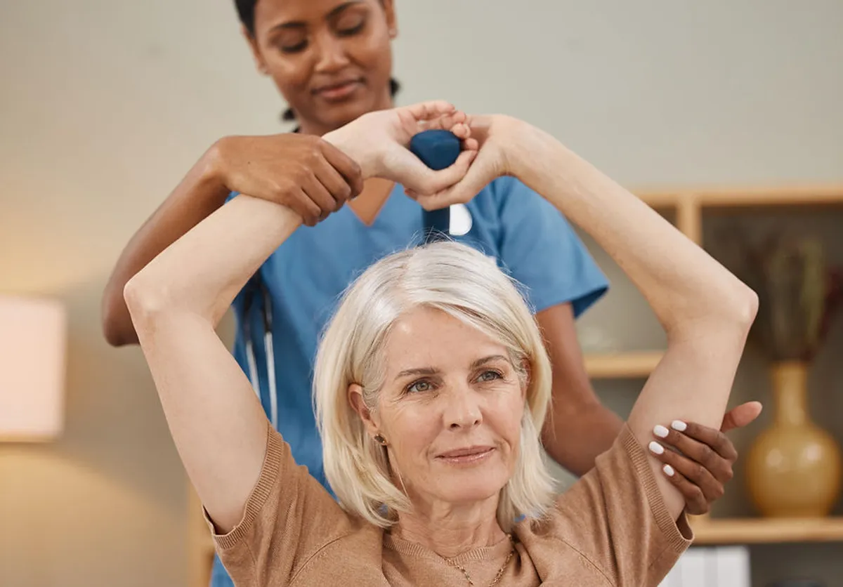 Senior woman doing physical therapy exercises at home with Pulse Home Health